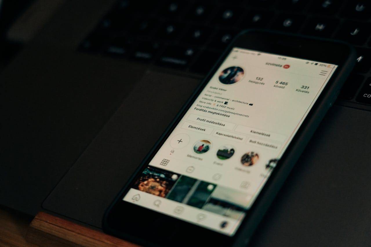 Instagram logo on a smartphone screen with marketing and sales icons in background